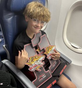 Landon on plane with trophies
